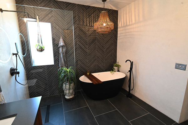 A bathroom with dark tiles remodeling project performed by CactusNectar LLC