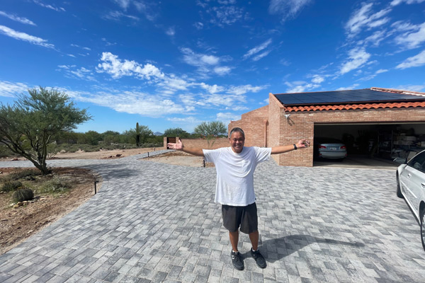 Happy client showing his finished driveway project in Southern Arizona