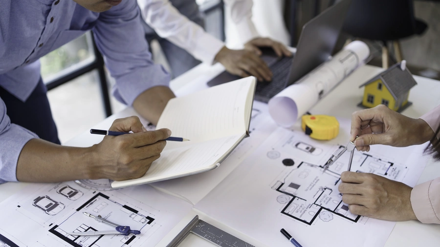 Clients checking a custom home construction project plan with the builders