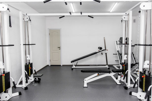 Image of a home gym addition project finished with modern gym machines in Tucson