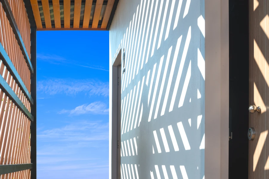 sunlight and shadow of wooden lattice in luxury custom home